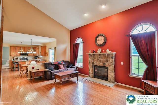 10 Windrift Ct, Easton, PA 18045 - living area with high vaulted ceiling, light wood-style floors, plenty of natural light, and a fireplace