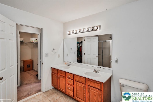 10 Windrift Ct, Easton, PA 18045 - bathroom featuring double vanity, a spacious closet, a shower stall, and tile patterned flooring