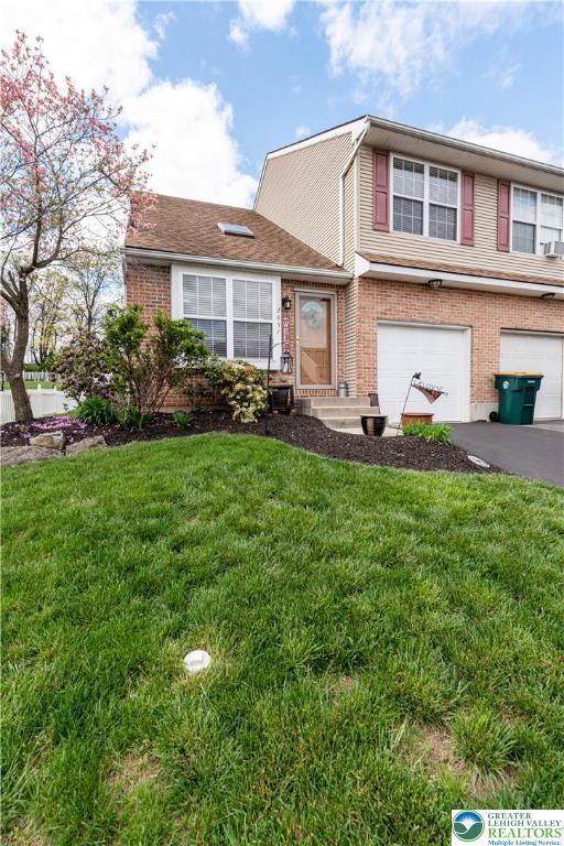 2657 Anthony Ct, Palmer Twp, PA 18045 - view of front of home with a garage, brick siding, driveway, and a front yard