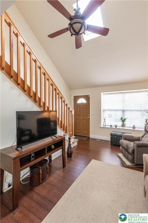 2657 Anthony Ct, Palmer Twp, PA 18045 - living room featuring stairs, ceiling fan, dark wood finished floors, and vaulted ceiling
