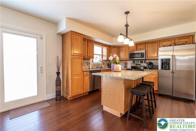 2657 Anthony Ct, Palmer Twp, PA 18045 - kitchen featuring appliances with stainless steel finishes, dark wood finished floors, backsplash, and a center island