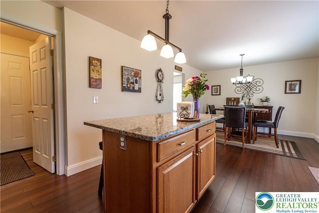 2657 Anthony Ct, Palmer Twp, PA 18045 - kitchen with dark wood-style flooring, a center island, light stone counters, and a chandelier