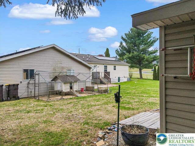 3954 Cedar Dr, Lehigh Twp, PA 18088 - back of house with a lawn, a patio area, and roof mounted solar panels