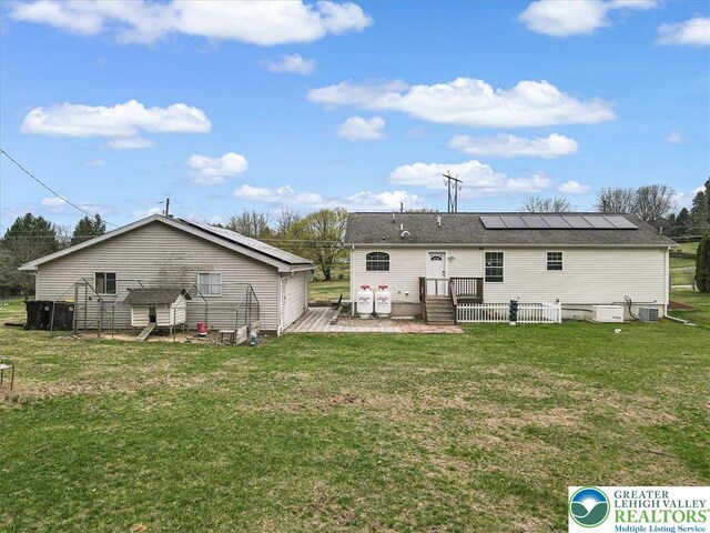 3954 Cedar Dr, Lehigh Twp, PA 18088 - rear view of property featuring solar panels and a yard