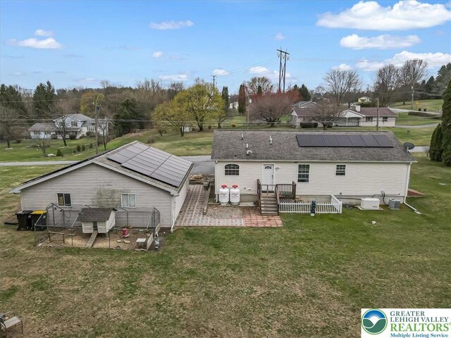 3954 Cedar Dr, Lehigh Twp, PA 18088 - back of property with roof mounted solar panels, a lawn, a patio area, and a deck