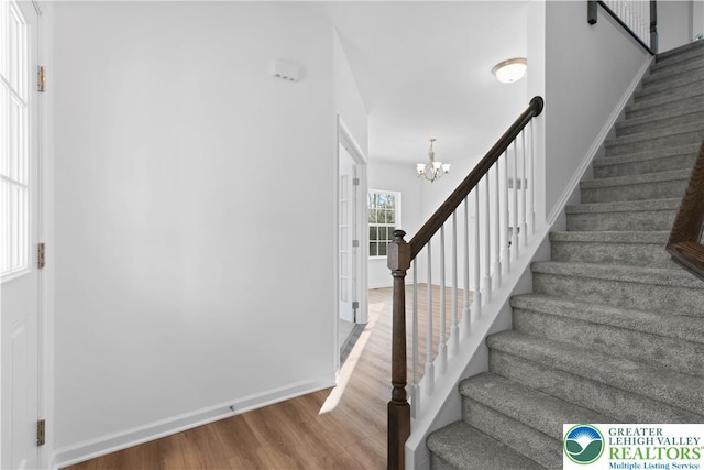718 Rte 314 Unit 2, Pocono Twp, PA 18370 - stairway featuring wood finished floors and a chandelier