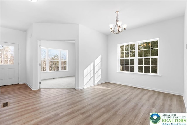 718 Rte 314 Unit 2, Pocono Twp, PA 18370 - unfurnished living room featuring a chandelier, light wood-type flooring, and healthy amount of natural light