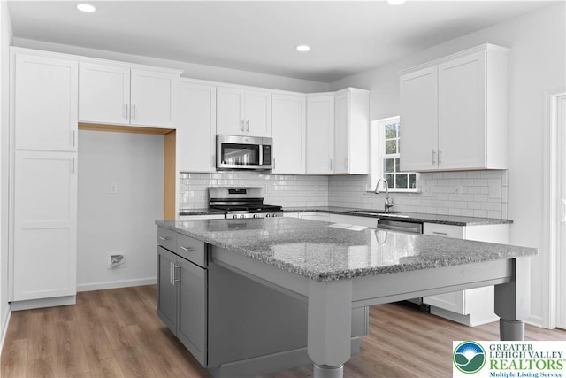 718 Rte 314 Unit 2, Pocono Twp, PA 18370 - kitchen featuring stainless steel appliances, a kitchen island, white cabinets, light wood-style flooring, and recessed lighting
