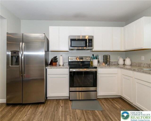 403 Lock Dr, Allen Twp, PA 18067 - kitchen featuring stainless steel appliances, dark wood-style floors, and white cabinets