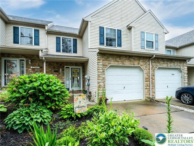 1778 Pinewind Dr, Alburtis Boro, PA 18011 - townhome / multi-family property with an attached garage, driveway, and stone siding