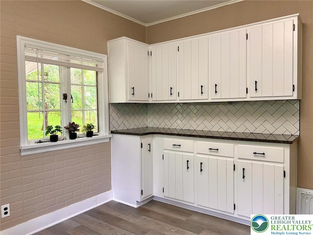 737 Frost Hollow Rd, Easton, PA 18040 - kitchen with dark countertops, dark wood-style floors, decorative backsplash, white cabinets, and ornamental molding