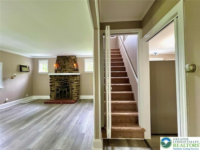 737 Frost Hollow Rd, Easton, PA 18040 - stairway featuring ornamental molding, wood finished floors, and a fireplace