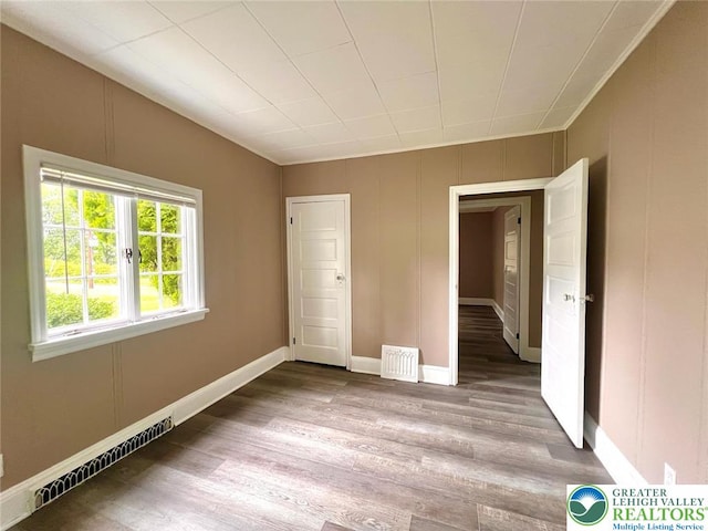 737 Frost Hollow Rd, Easton, PA 18040 - empty room with wood finished floors and a baseboard heating unit