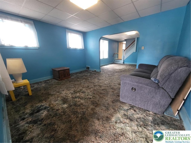 419 E Walnut St, Allentown City, PA 18109 - unfurnished living room with arched walkways, carpet flooring, a paneled ceiling, and stairs