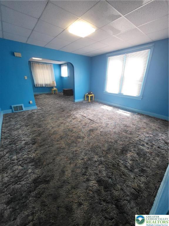 419 E Walnut St, Allentown City, PA 18109 - carpeted empty room with arched walkways and a drop ceiling