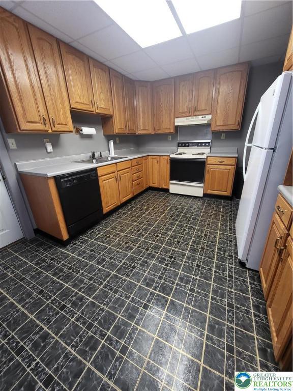 419 E Walnut St, Allentown City, PA 18109 - kitchen with white appliances, a paneled ceiling, under cabinet range hood, light countertops, and brown cabinets