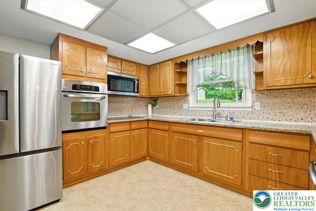 627 Columbia Ave, Palmerton Boro, PA 18071 - kitchen with appliances with stainless steel finishes, open shelves, brown cabinetry, light stone counters, and tasteful backsplash