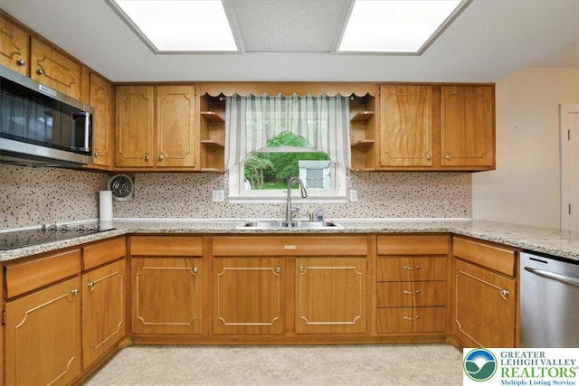627 Columbia Ave, Palmerton Boro, PA 18071 - kitchen featuring stainless steel appliances, open shelves, brown cabinetry, and light stone countertops