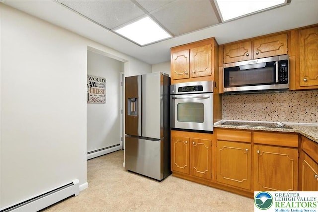627 Columbia Ave, Palmerton Boro, PA 18071 - kitchen with appliances with stainless steel finishes, a baseboard radiator, brown cabinetry, and light carpet
