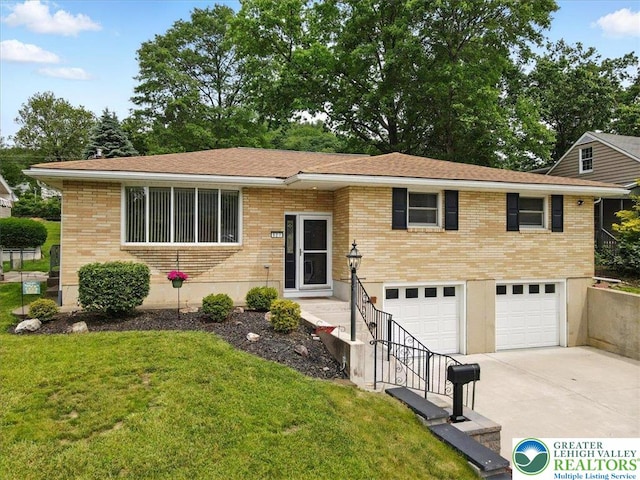 627 Columbia Ave, Palmerton Boro, PA 18071 - view of front of house featuring concrete driveway, an attached garage, a front yard, and brick siding