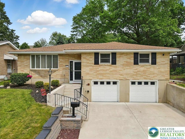 627 Columbia Ave, Palmerton Boro, PA 18071 - view of front of home featuring a garage, driveway, a front lawn, and brick siding