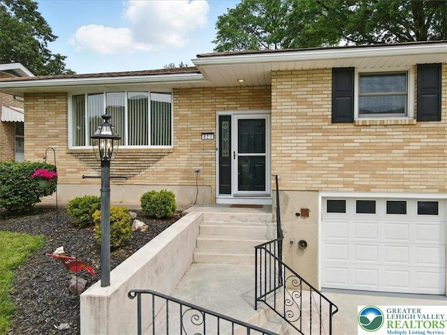 627 Columbia Ave, Palmerton Boro, PA 18071 - doorway to property with an attached garage and brick siding