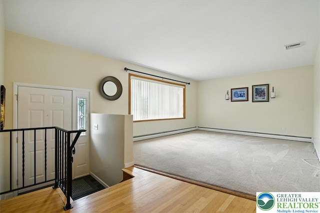627 Columbia Ave, Palmerton Boro, PA 18071 - carpeted foyer entrance with healthy amount of natural light, a baseboard radiator, and wood finished floors