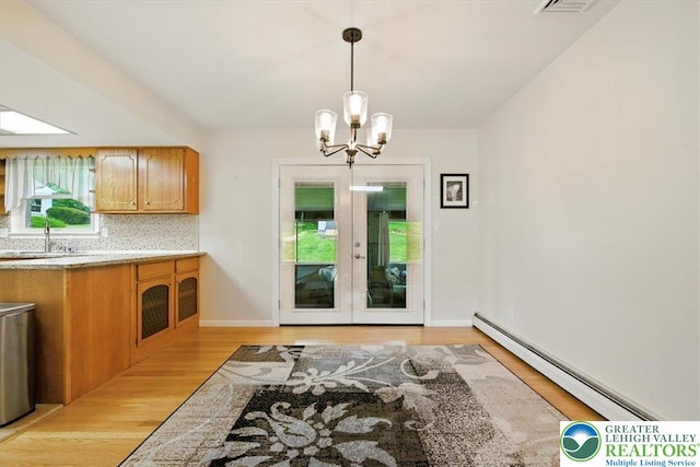 627 Columbia Ave, Palmerton Boro, PA 18071 - kitchen featuring a baseboard radiator, a chandelier, light countertops, french doors, and light wood-style flooring