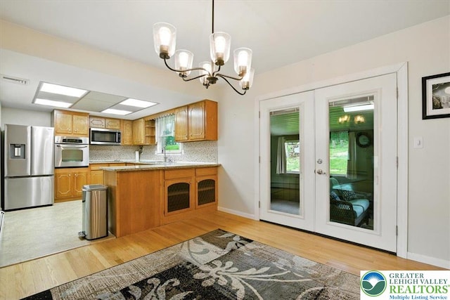 627 Columbia Ave, Palmerton Boro, PA 18071 - kitchen with stainless steel appliances, light wood-style floors, french doors, and a peninsula