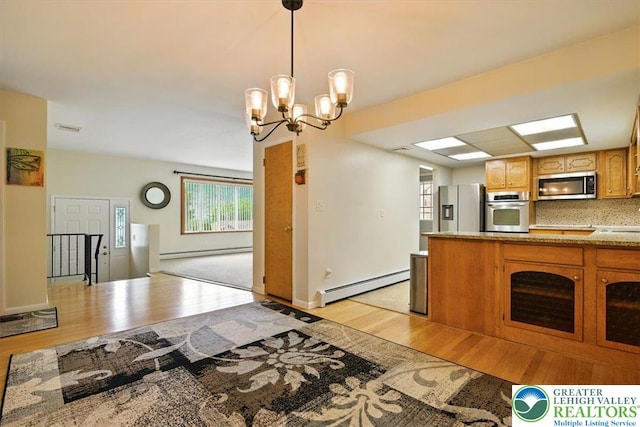 627 Columbia Ave, Palmerton Boro, PA 18071 - kitchen with appliances with stainless steel finishes, a baseboard radiator, light wood finished floors, and a chandelier