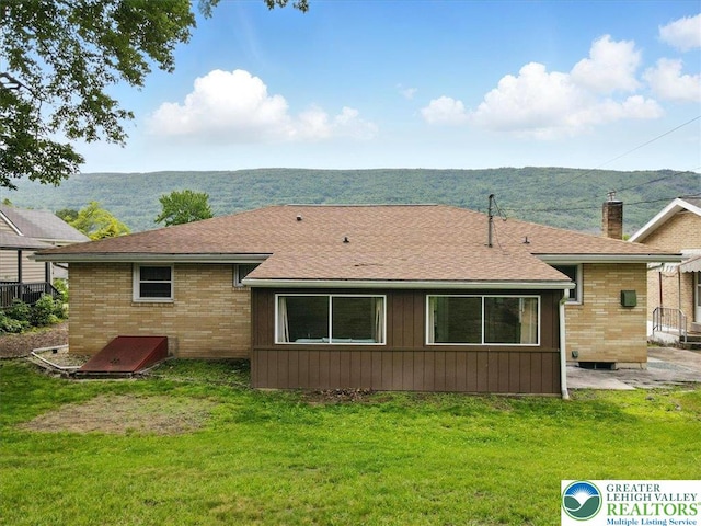 627 Columbia Ave, Palmerton Boro, PA 18071 - back of house featuring a lawn, brick siding, a chimney, and roof with shingles