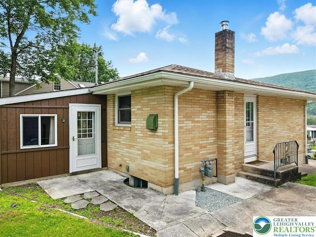 627 Columbia Ave, Palmerton Boro, PA 18071 - rear view of property with a chimney and brick siding