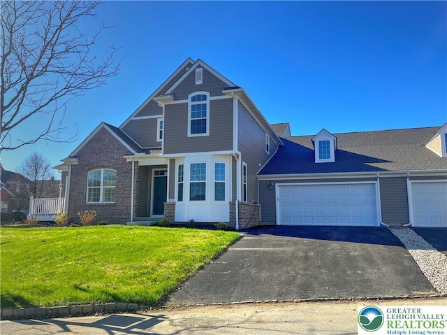 868 Veneto Ct, Forks Twp, PA 18040 - view of front of home with driveway, a front lawn, brick siding, and an attached garage