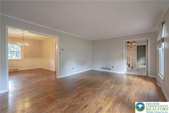 1265 Clearview Cir, Lower Macungie Twp, PA 18103 - spare room with a chandelier, stairway, wood finished floors, and ornamental molding