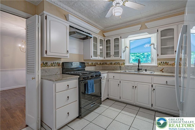 1265 Clearview Cir, Lower Macungie Twp, PA 18103 - kitchen with black range with gas cooktop, white refrigerator, exhaust hood, a ceiling fan, and glass insert cabinets