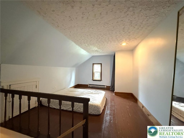 233 Lafayette Ave, Palmerton Boro, PA 18071 - unfurnished bedroom featuring a baseboard radiator, lofted ceiling, a textured ceiling, and hardwood / wood-style floors