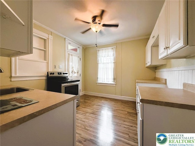 233 Lafayette Ave, Palmerton Boro, PA 18071 - kitchen with stainless steel range with electric stovetop, light wood-style floors, crown molding, and a ceiling fan