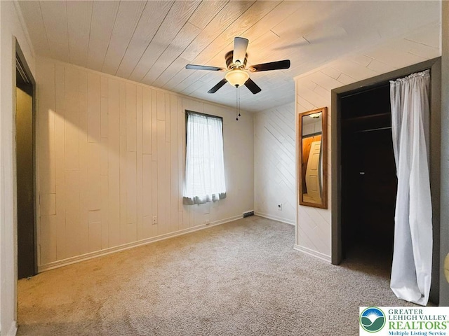233 Lafayette Ave, Palmerton Boro, PA 18071 - unfurnished bedroom with wood walls, carpet, wooden ceiling, and a ceiling fan
