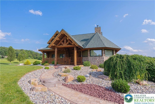 379 Meyer Rd, Bushkill Twp, PA 18064 - log-style house with a porch, a chimney, a front yard, and stone siding