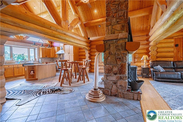 379 Meyer Rd, Bushkill Twp, PA 18064 - dining room with a wooden ceiling with exposed beams, rustic walls, a wood stove, high vaulted ceiling, and arched walkways