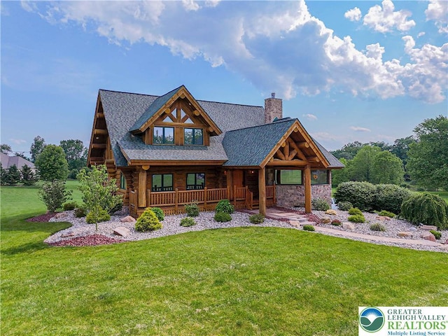 379 Meyer Rd, Bushkill Twp, PA 18064 - log home with a chimney, covered porch, a front yard, log exterior, and stone siding