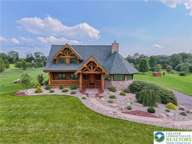 379 Meyer Rd, Bushkill Twp, PA 18064 - log-style house featuring covered porch, a front lawn, a chimney, and stone siding