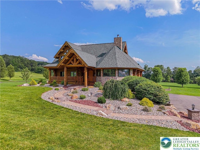 379 Meyer Rd, Bushkill Twp, PA 18064 - log home featuring covered porch, a front yard, and a chimney