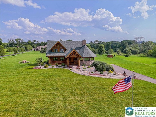 379 Meyer Rd, Bushkill Twp, PA 18064 - cabin featuring covered porch, a front yard, and a chimney