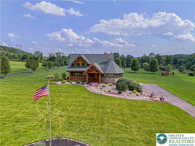 379 Meyer Rd, Bushkill Twp, PA 18064 - log-style house featuring a porch, a front lawn, and a chimney
