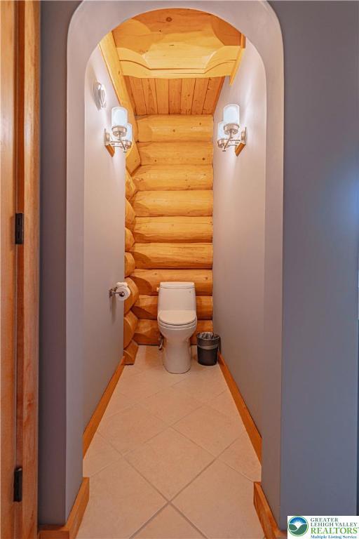 379 Meyer Rd, Bushkill Twp, PA 18064 - bathroom featuring log walls, tile patterned flooring, and wood ceiling