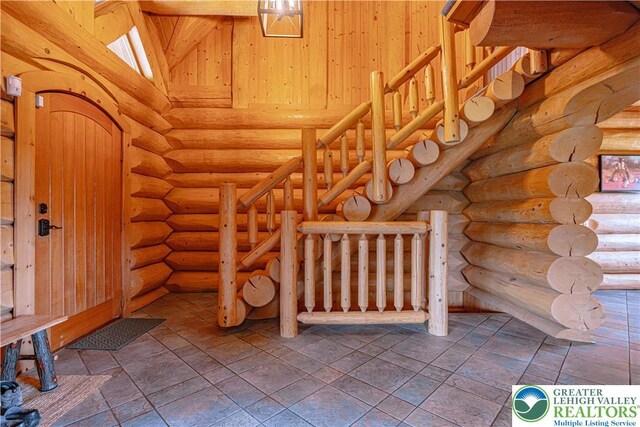 379 Meyer Rd, Bushkill Twp, PA 18064 - entrance foyer with log walls and stairs