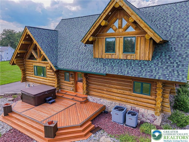 379 Meyer Rd, Bushkill Twp, PA 18064 - back of house featuring a hot tub, log siding, a wooden deck, and roof with shingles