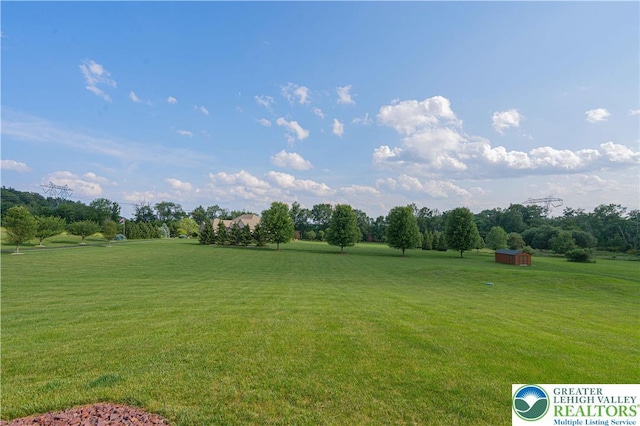 379 Meyer Rd, Bushkill Twp, PA 18064 - view of grassy yard with a storage shed and view of wooded area