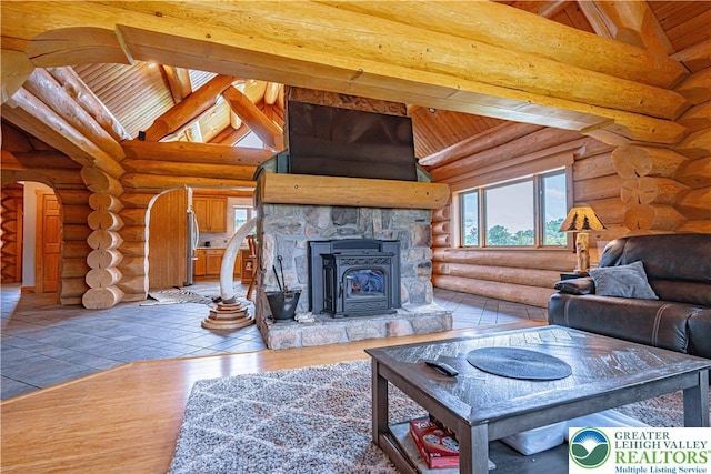 379 Meyer Rd, Bushkill Twp, PA 18064 - living room featuring arched walkways, a wood ceiling with exposed beams, wood finished floors, high vaulted ceiling, and rustic walls